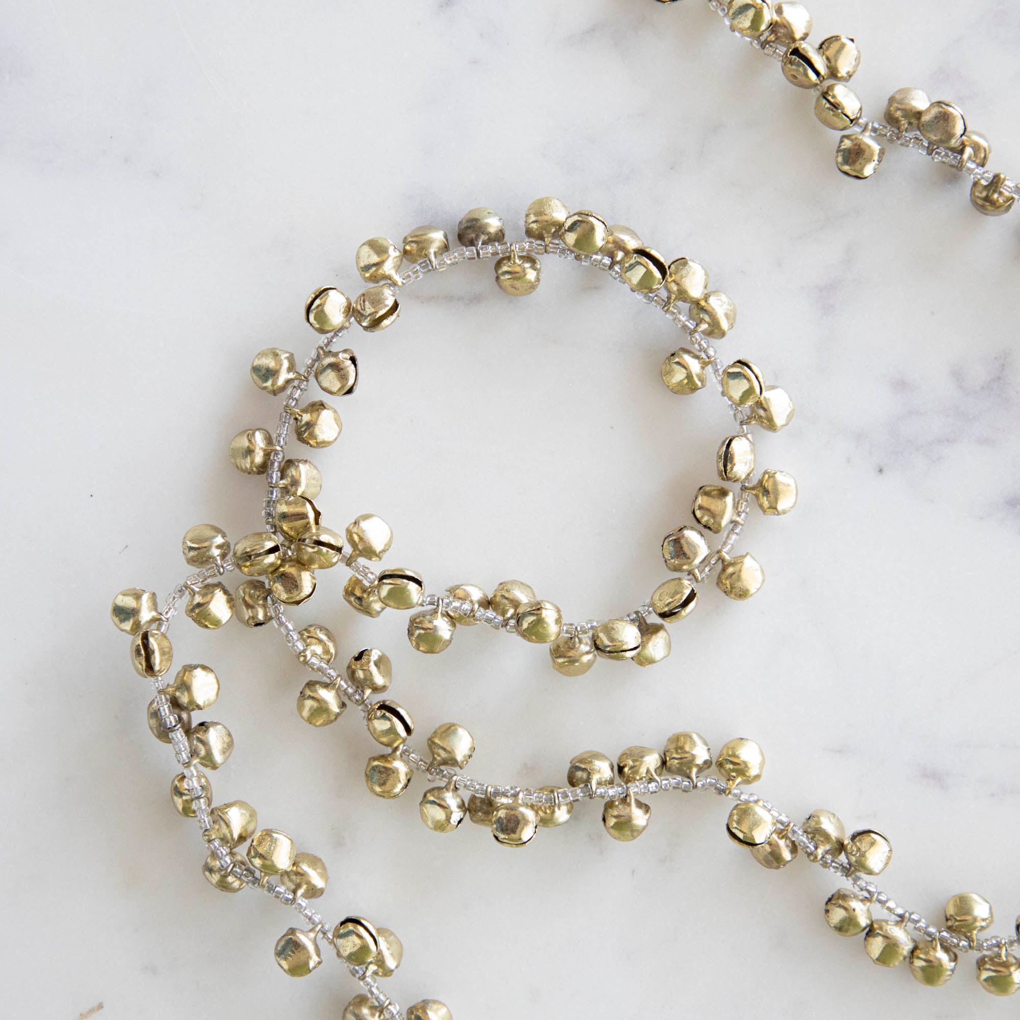 Close up of the Bell Garland showing its tiny bells and beaded string.