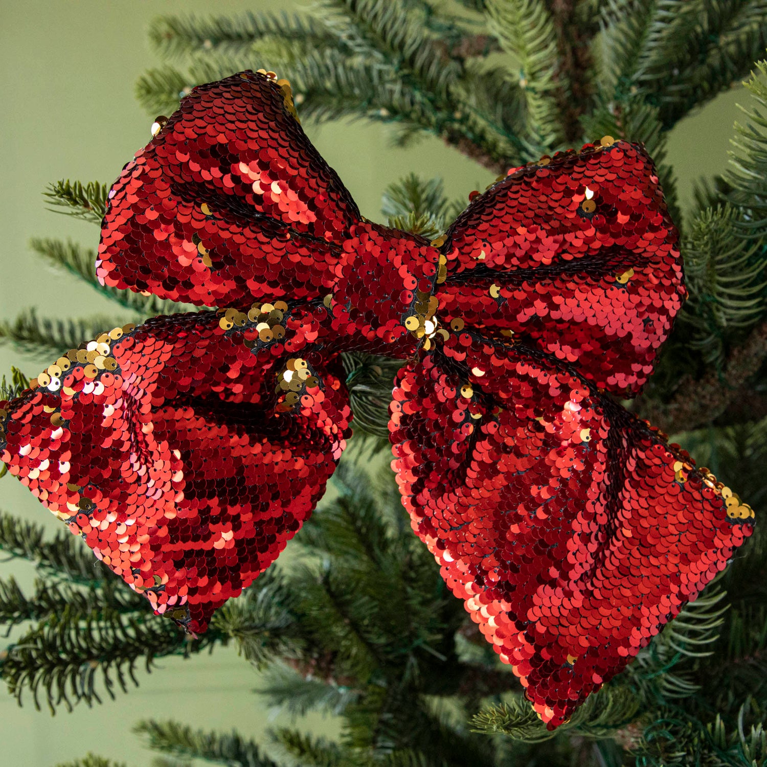 A close up of the red Puffy Sequin Bow Ornament.