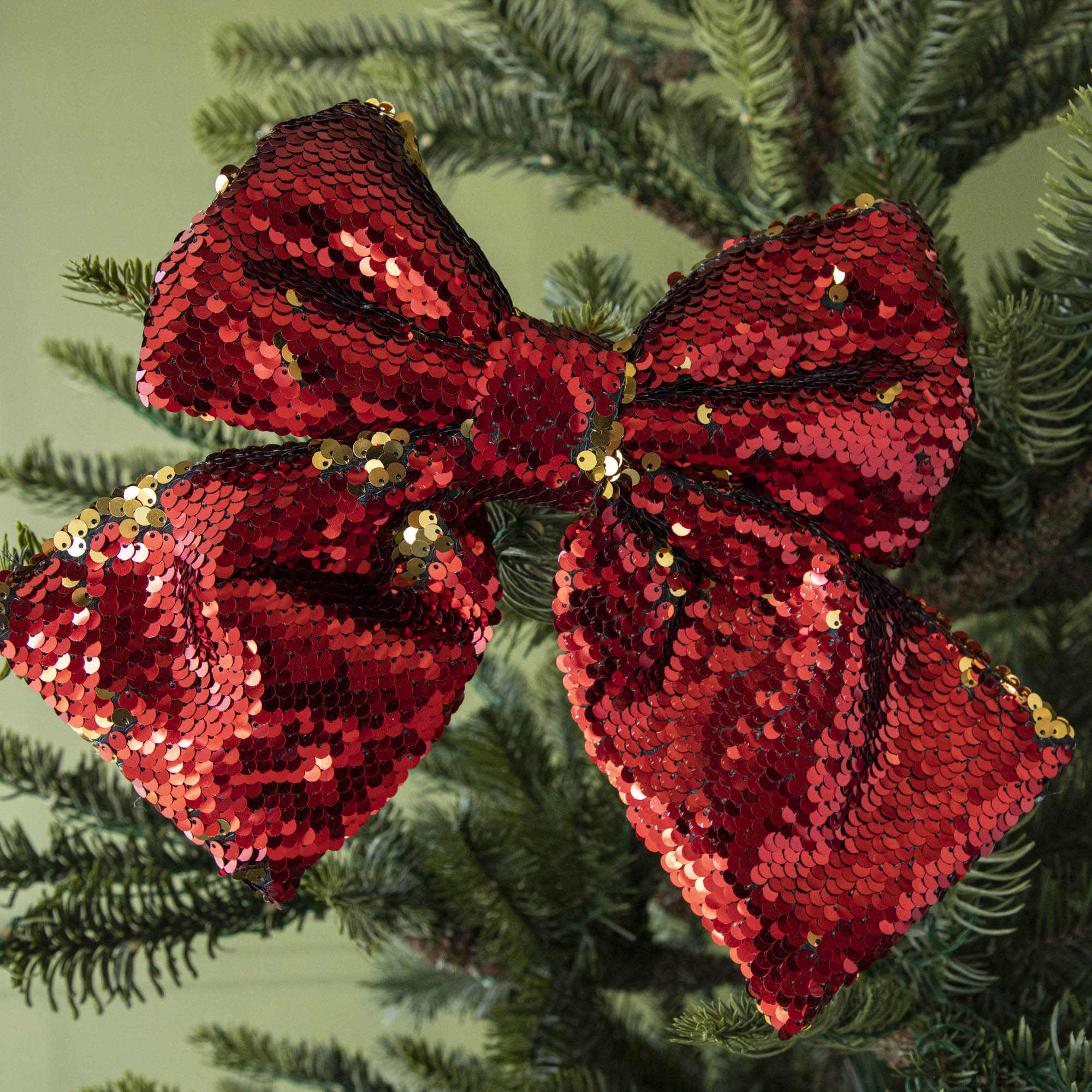 A close up of the red Puffy Sequin Bow Ornament.