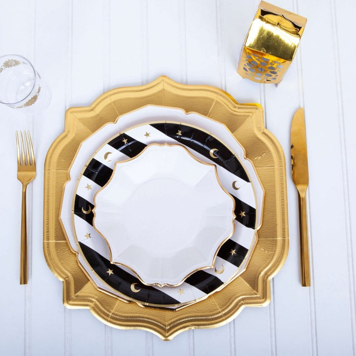 A stunning Christmas table setting adorned with gold and pomegranate accents, featuring elegant Eid Creations White Scalloped Plates with Gold Rim.