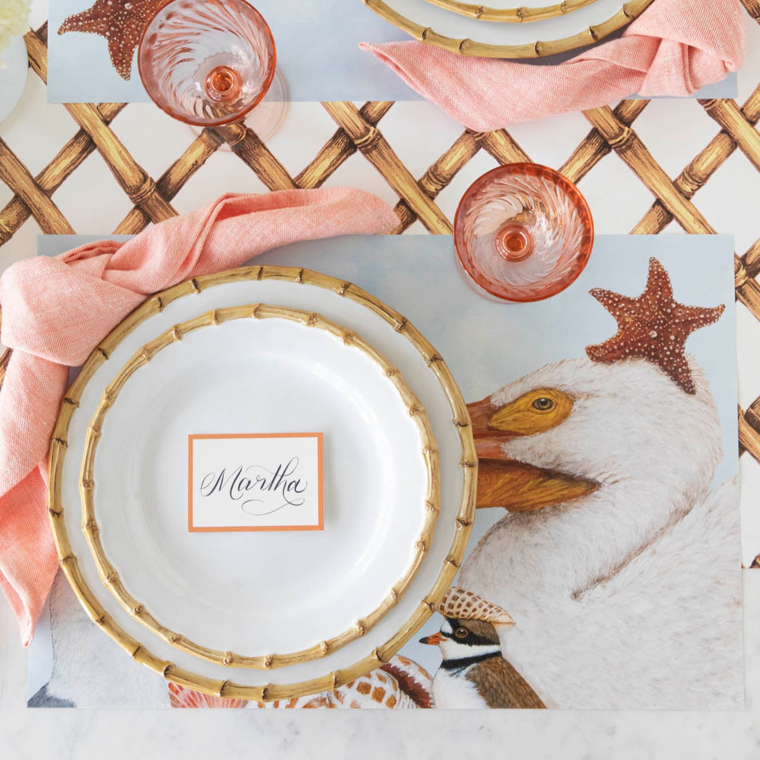 A coastal table setting with the Shorebirds Placemat under a place setting and Bamboo Lattice Runner underneath.