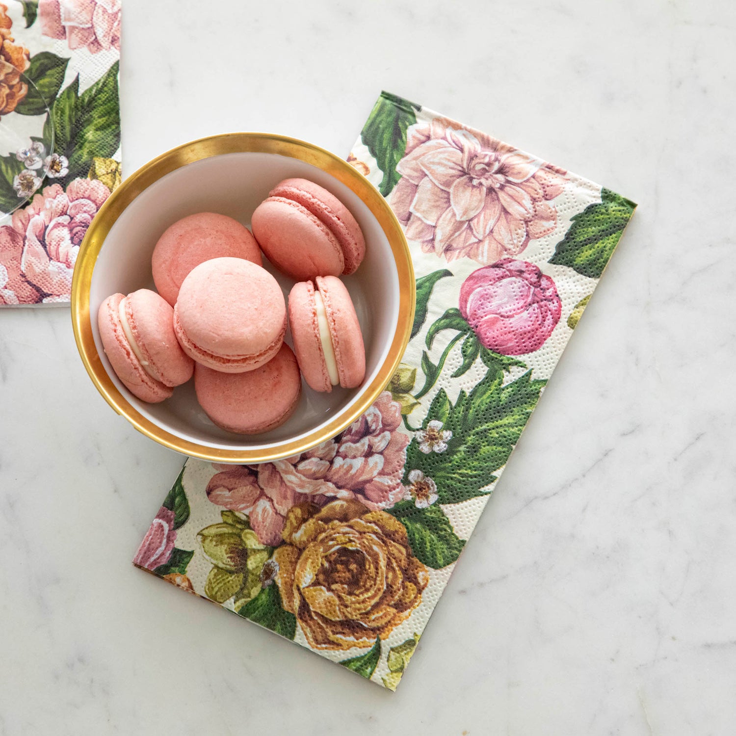 Garden Derby Guest Napkin slightly underneath a bowl of macaroons.