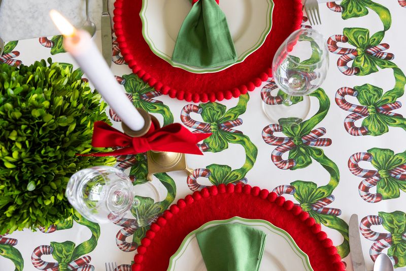 A candy cane themed runner on a holiday tablescape. 