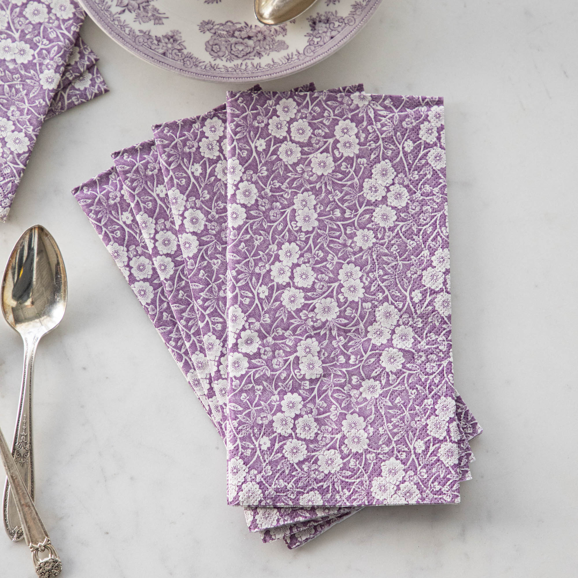 Exquisitely decorated Lilac Calico Napkins by Hester &amp; Cook on a marble table.