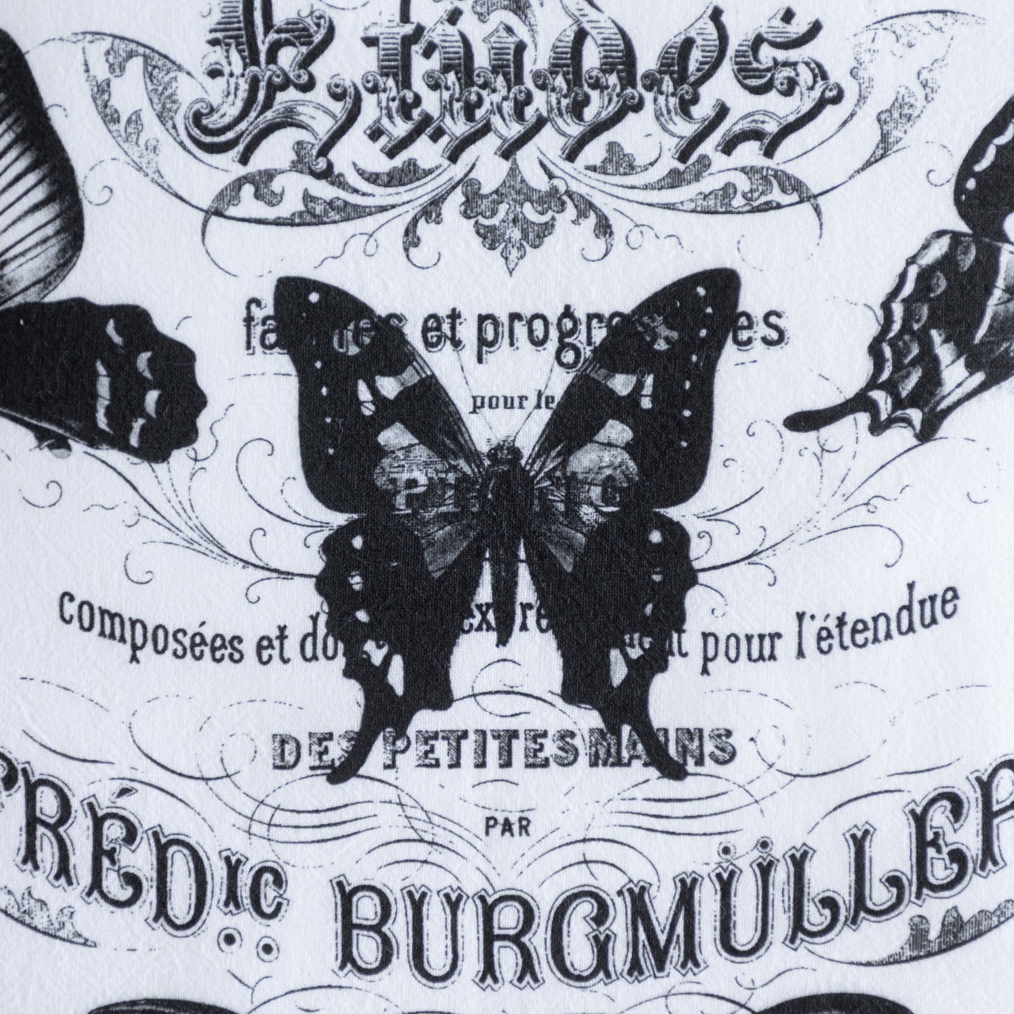 Close up of the Butterflies French Cotton Tea Towel showing a butterfly design with vintage text and decorative elements.