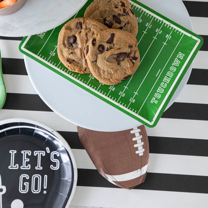 Football theme paper dinnerware on a black stripe runner.