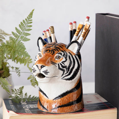A set of quirky Quail tiger ceramic vases on a wooden table.