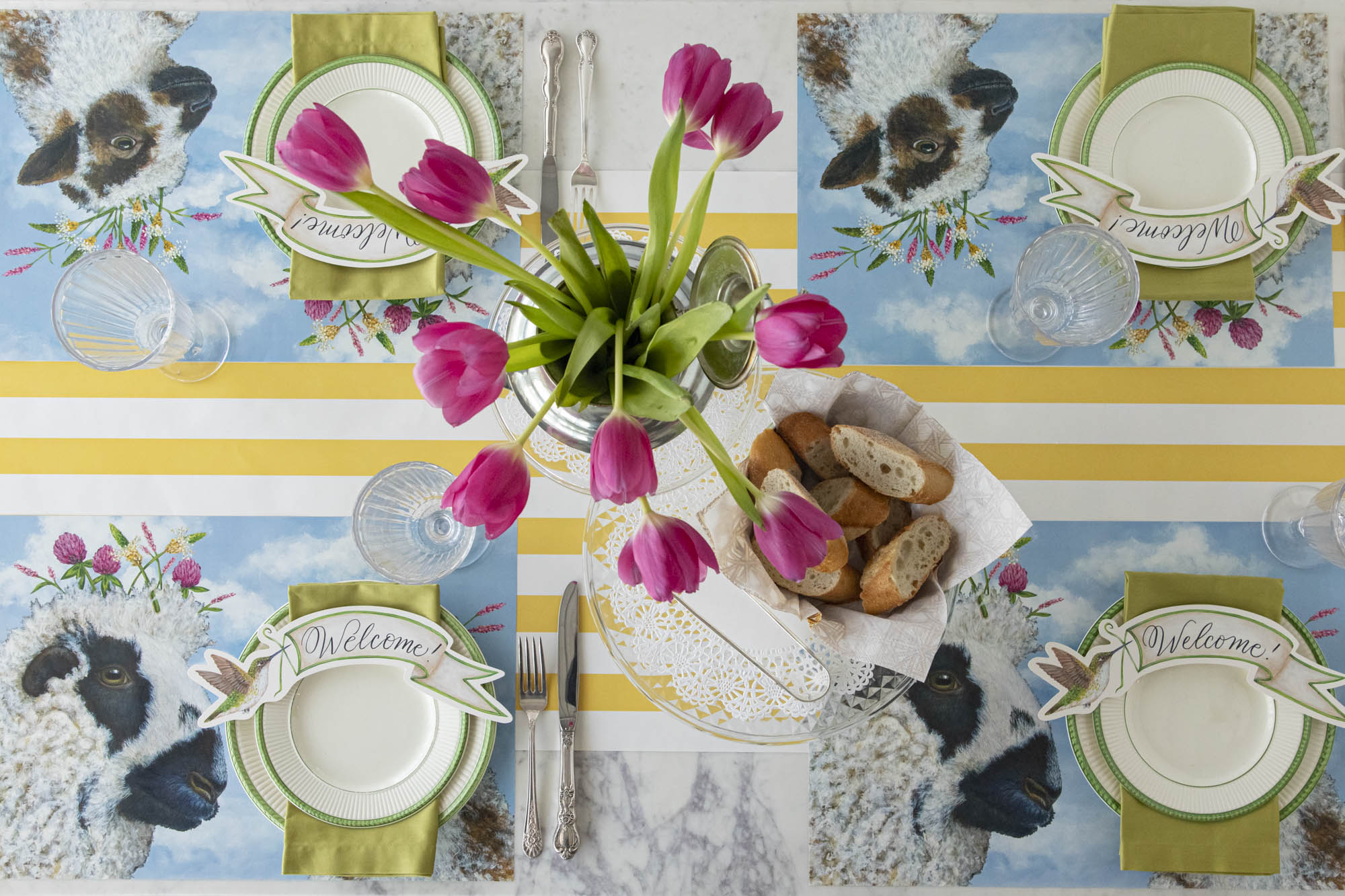 A spring table setting with an I Love Ewe Placemat centerpiece and tulips. (Brand Name: Hester &amp; Cook)