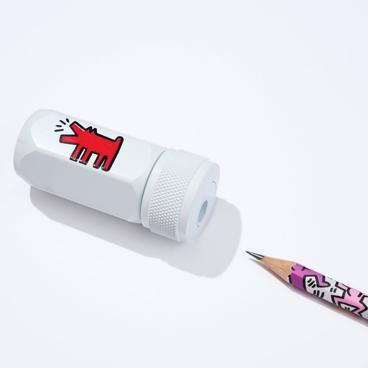 White Blackwing pencil sharpener with Keith Haring artwork of a dog barking. 