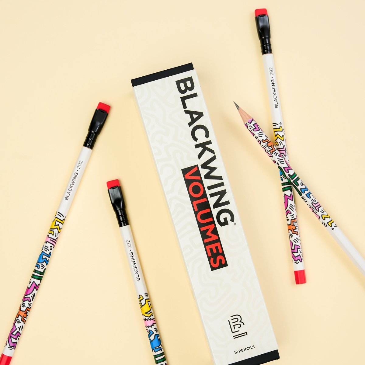 Blackwing Volumes pencils with colorful artwork by Keith Haring on a beige background.