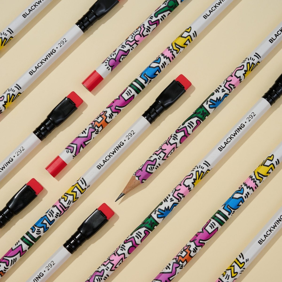 Blackwing pencils with colorful designs on a beige background.