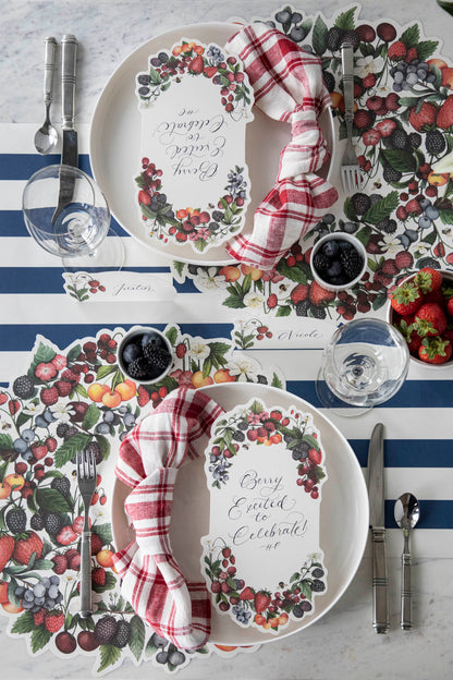 A tablescape adorned with plates, napkins, and an array of vibrant Berry Bramble Table Cards by Hester &amp; Cook.
