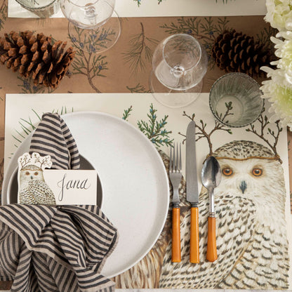 Table setting with a Winter Owls Placemat with dinnerware on top and a Juniper Sprigs Runner underneath.