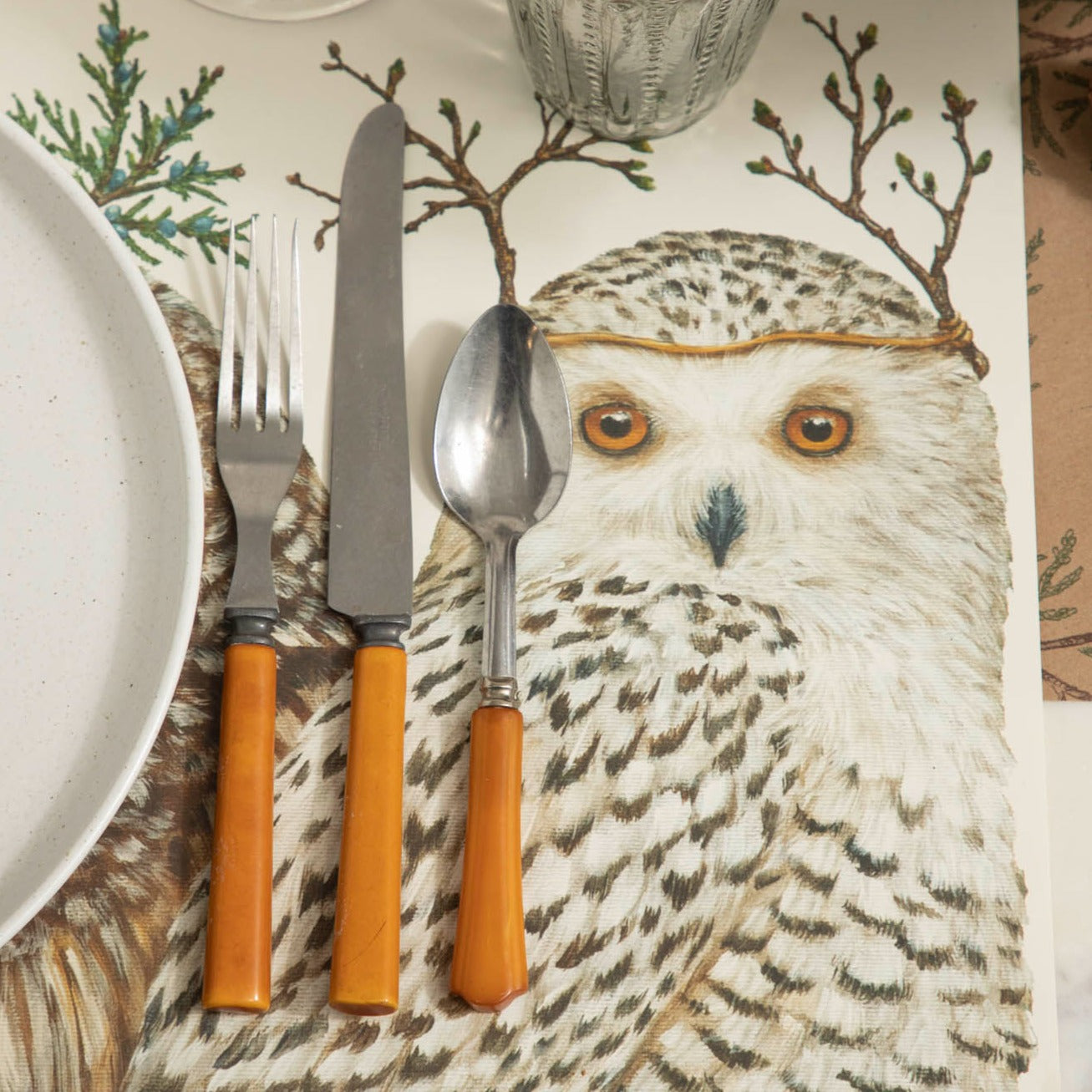 Winter Owls Placemat with brown handled silverware and glasses on top of a Juniper Sprigs runner.