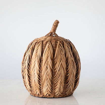 A large woven pumpkin on marble.