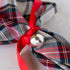 Plaid napkin tied with a red ribbon and Silver Ball Mercury Glass Ornament.