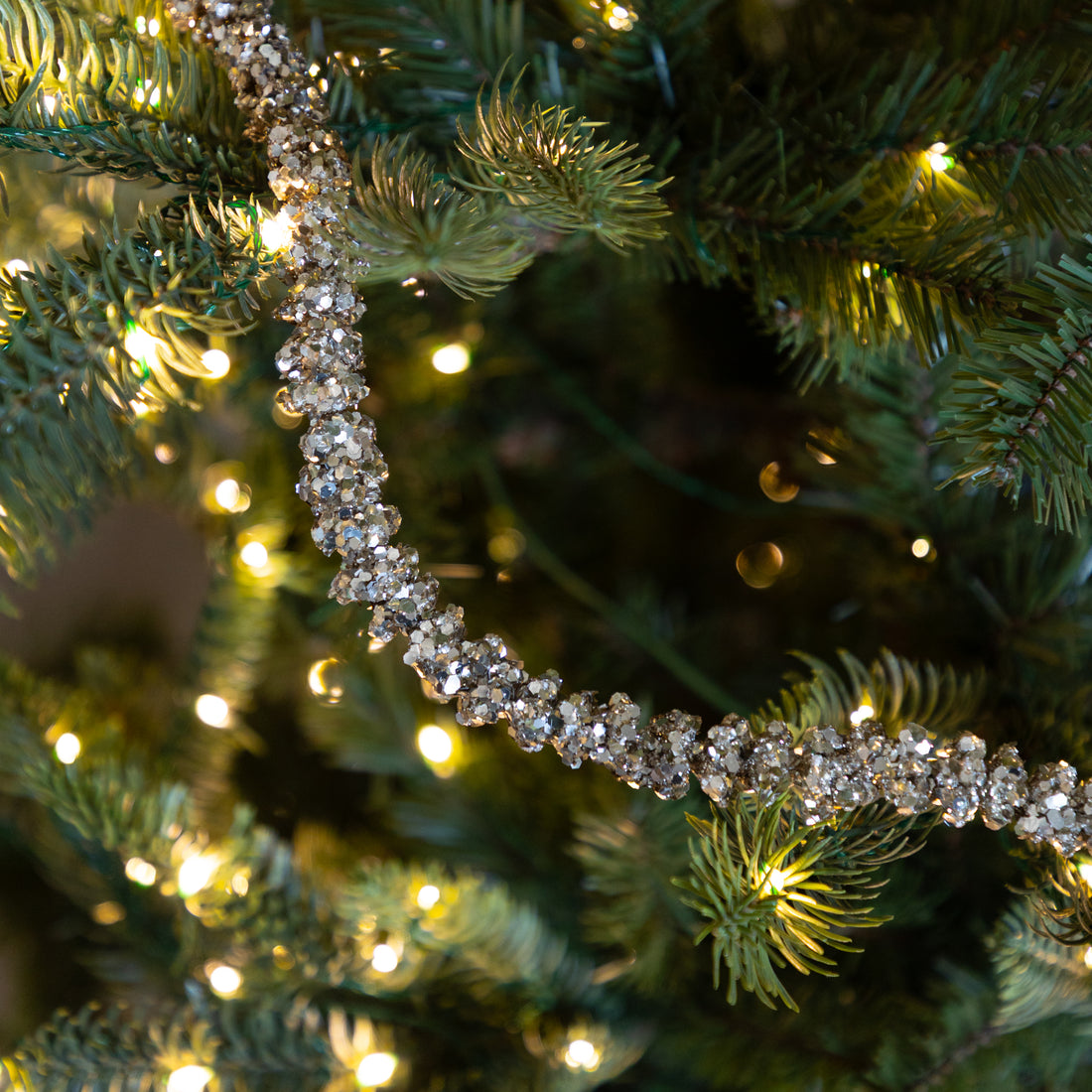 Champagne Glitter Garland on a lit Christmas tree.