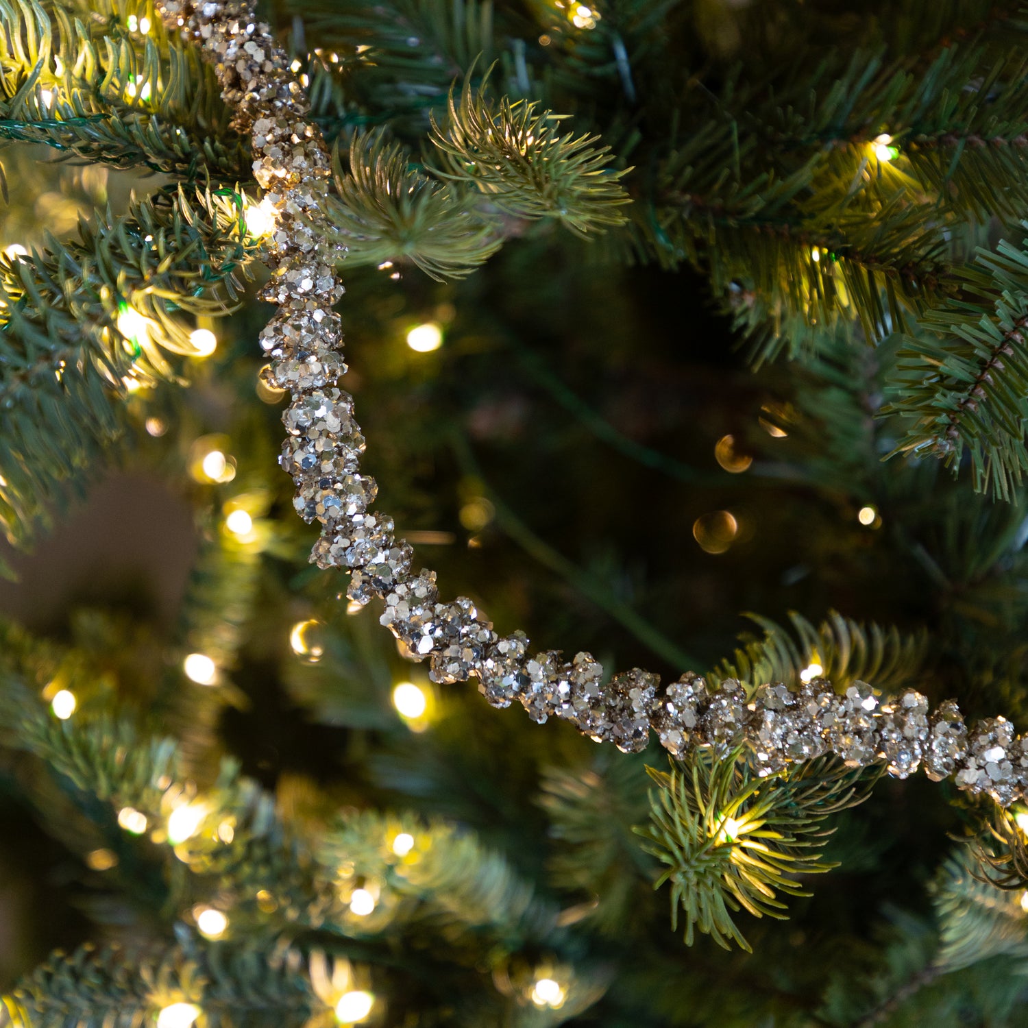 Champagne Glitter Garland on a lit Christmas tree.