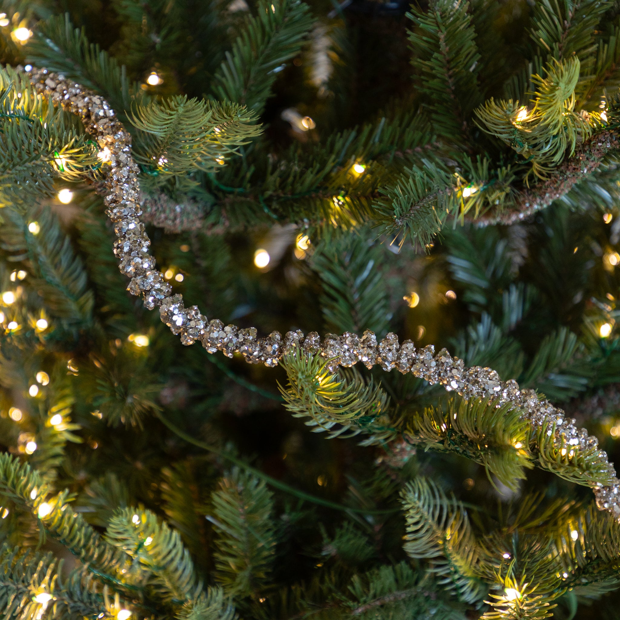 Champagne Glitter Garland on a lit Christmas tree.