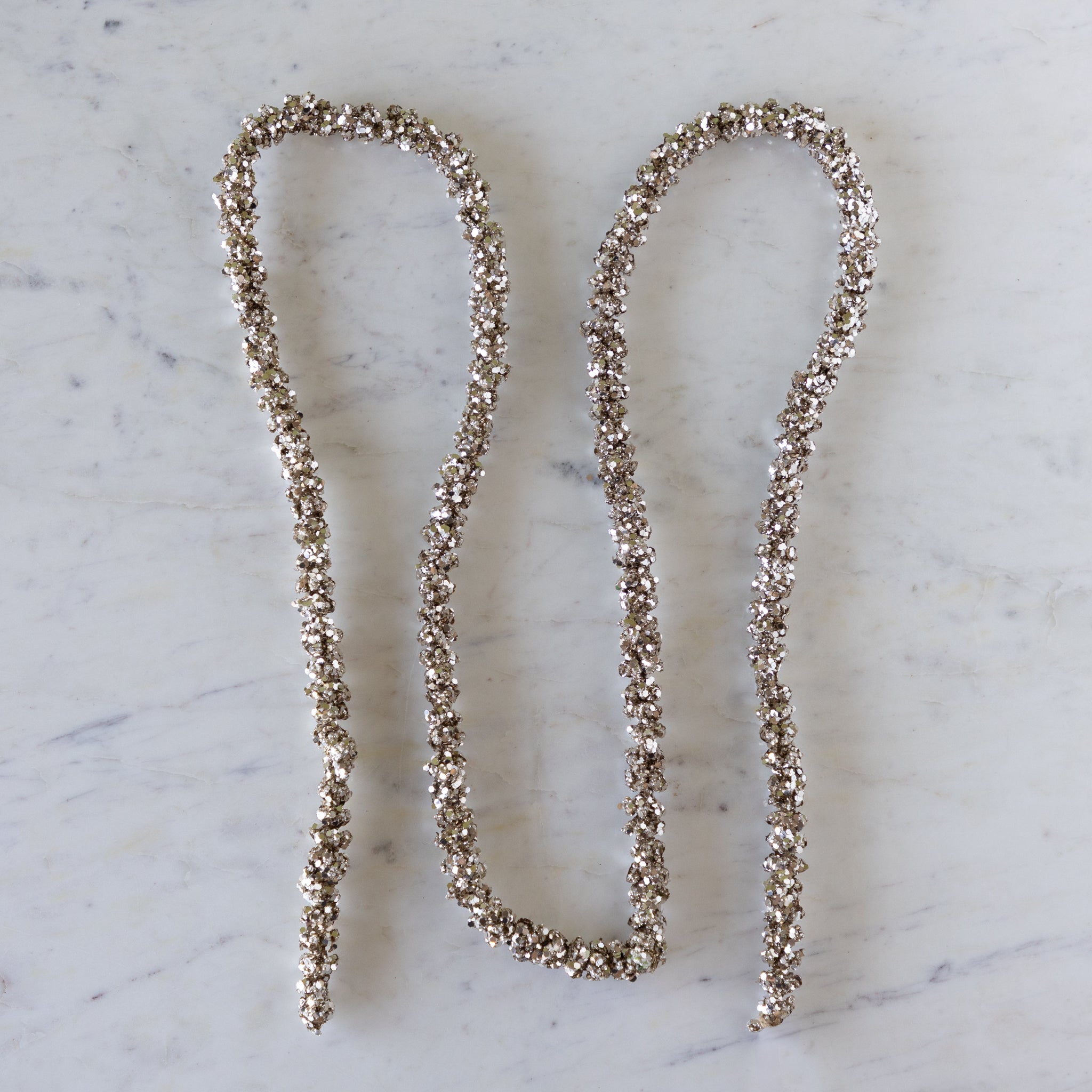 Champagne Glitter Garland on a marble table.