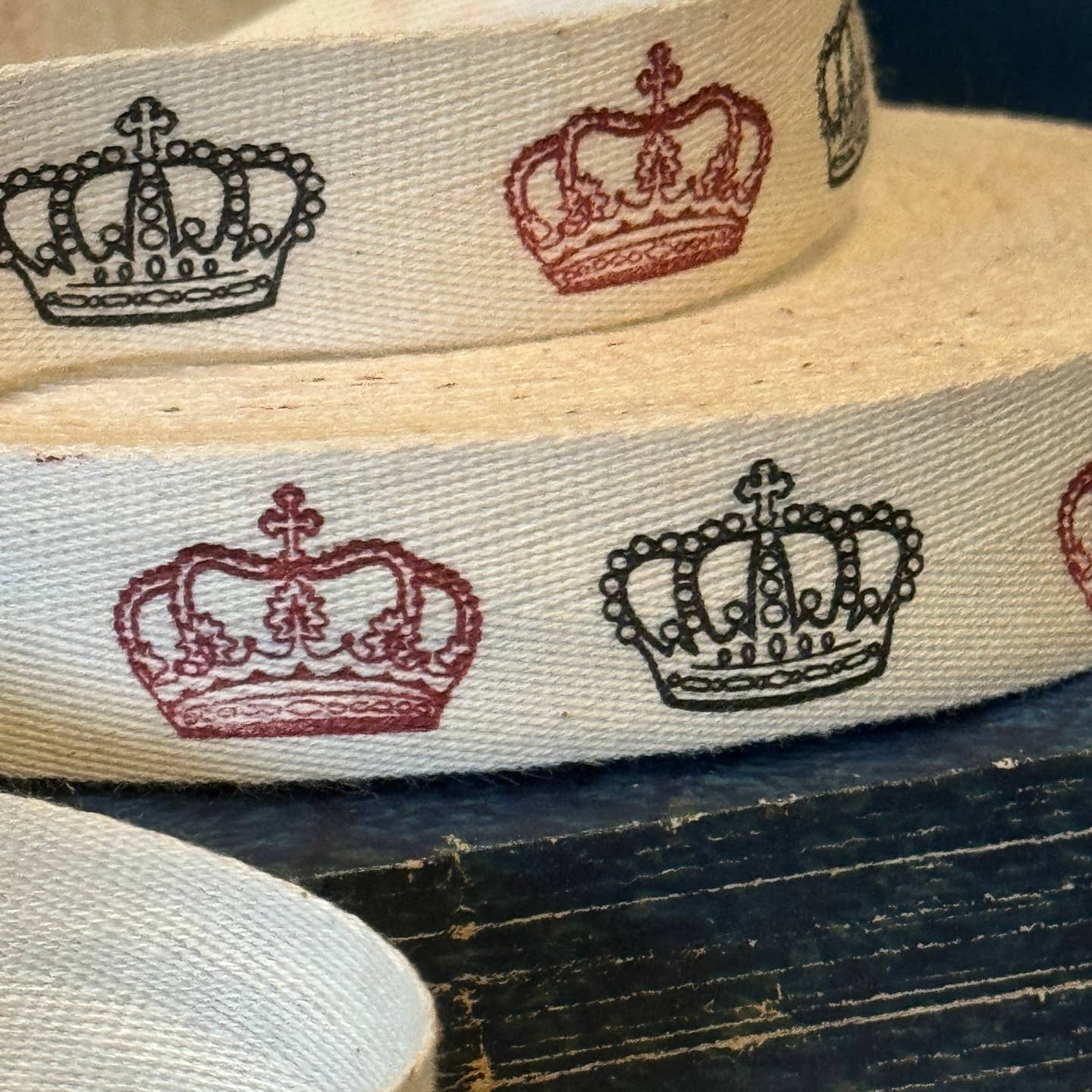 Ribbon printed with red and black crowns. 