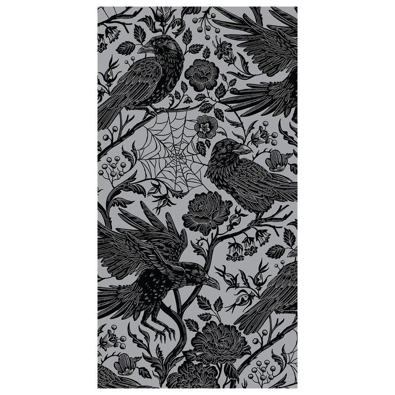 A rectangular guest napkin featuring an illustrated pattern of black birds and flowers on a metallic silver background.