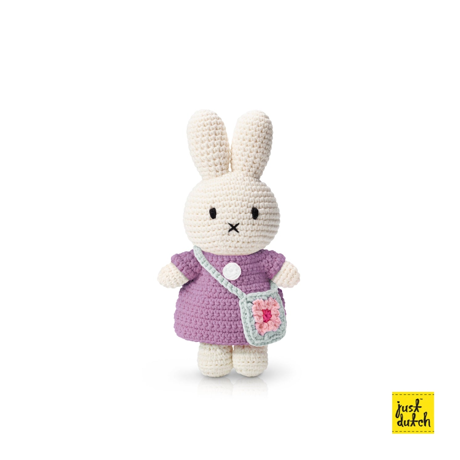A plush toy of a rabbit wearing a lilac dress with a blue flower bag, on a white background.
