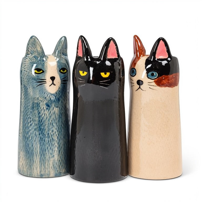 Three ceramic cat vases in blue, black, and brown, on a white background. 