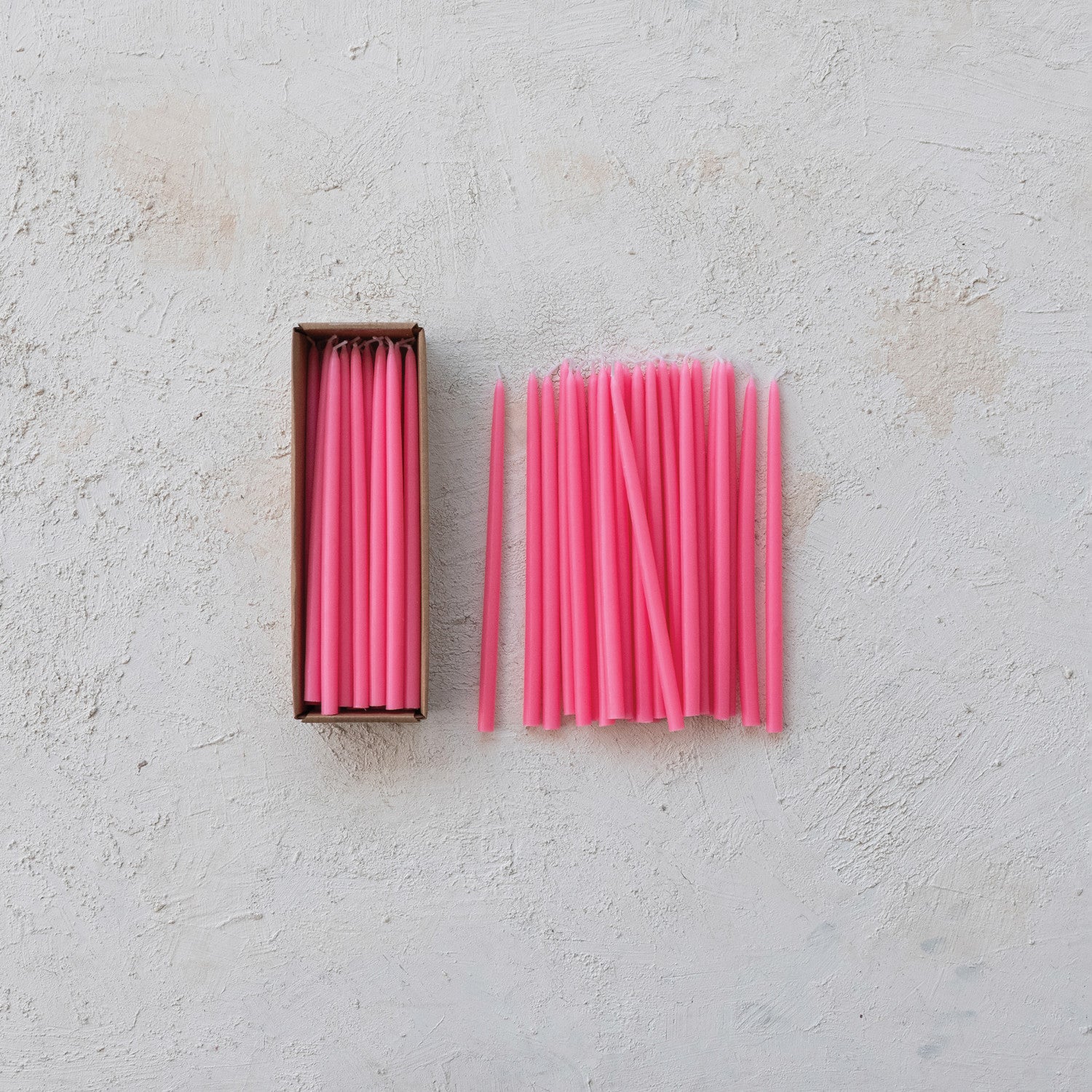 Pink candles on a light gray surface