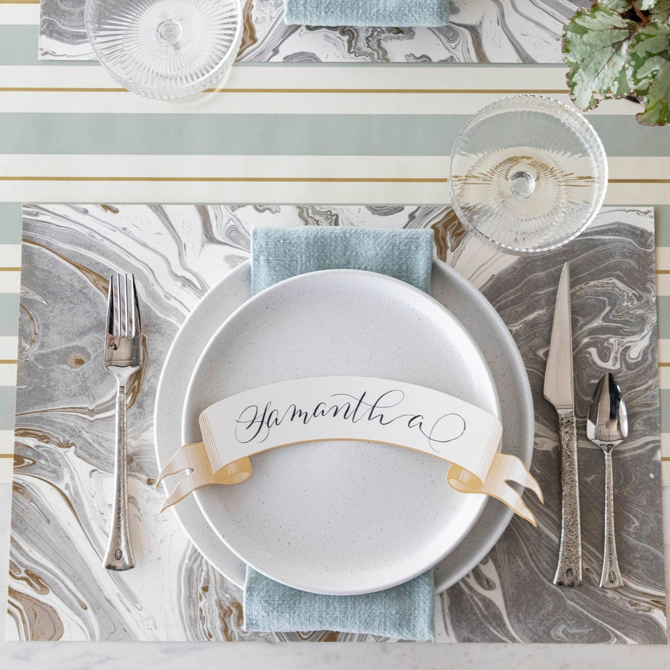 An entertaining table setting with a Hester &amp; Cook Slate &amp; Gold Awning Stripe Runner and silverware.