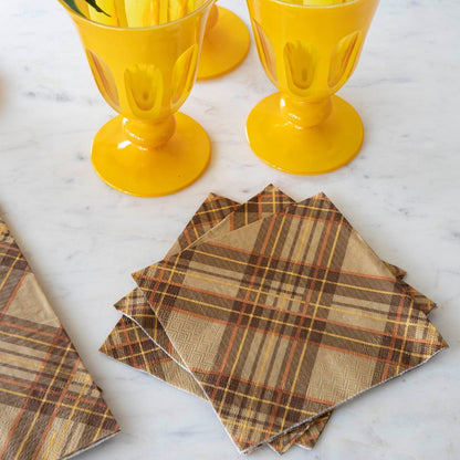 Rustic Hester &amp; Cook autumn plaid napkins and glasses adorn the elegant marble table, creating a perfect Thanksgiving ambiance.