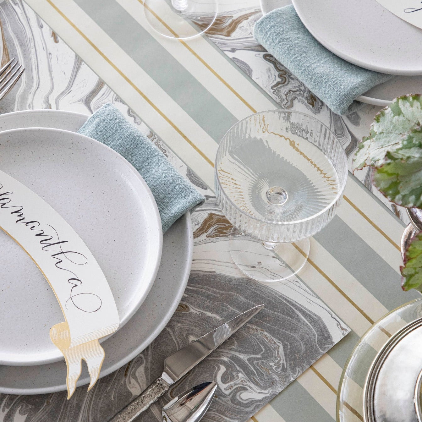 An entertaining table setting with Slate &amp; Gold Awning Stripe Runner plates, silverware, and napkins by Hester &amp; Cook.