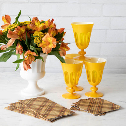 A yellow vase with orange flowers and Autumn Plaid Napkins by Hester &amp; Cook on a table.