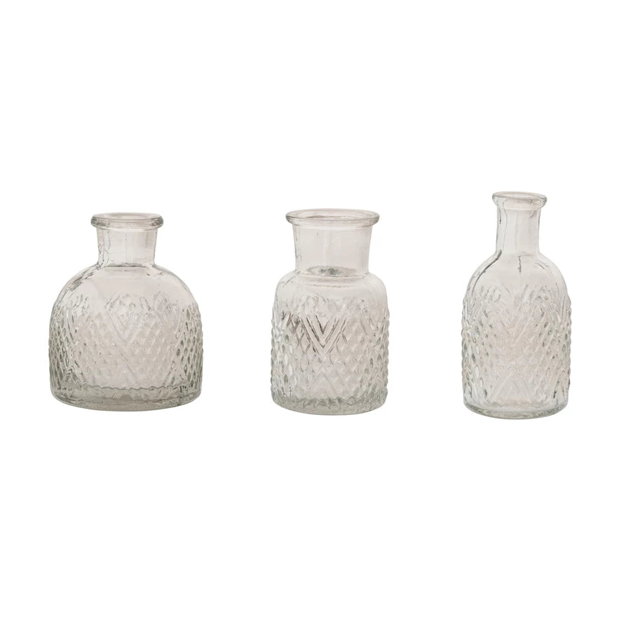 Three textured glass vases on a white background.