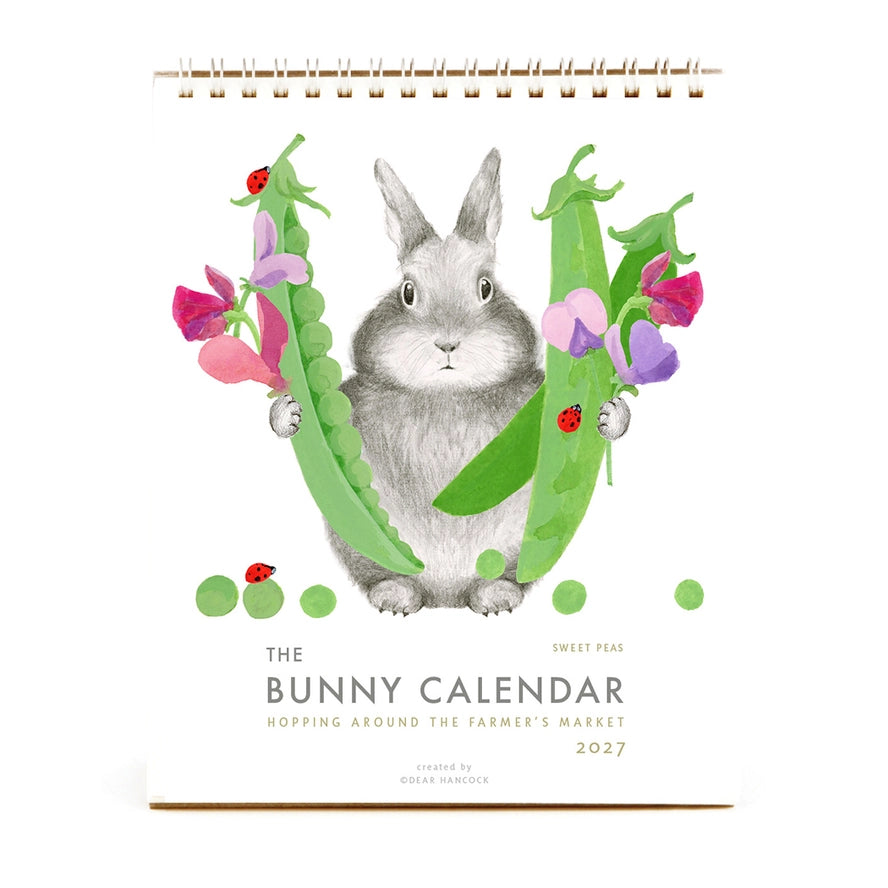 Calendar cover with a rabbit illustration surrounded by peas and flowers on a white background
