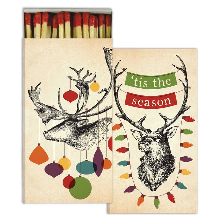 Decorative matchbox with an illustration of a stag with ornaments hanging from its antlers and the message &
