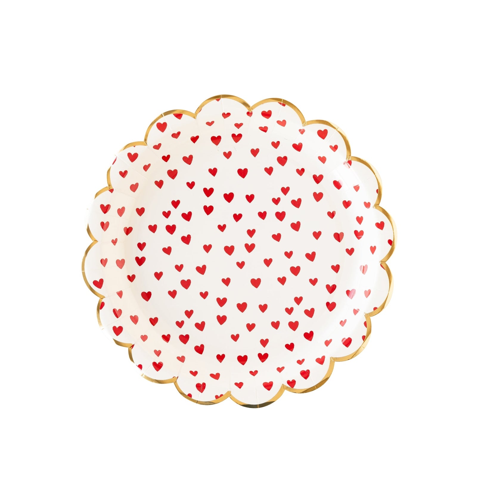 A white scalloped plate with small red hearts printed on it.