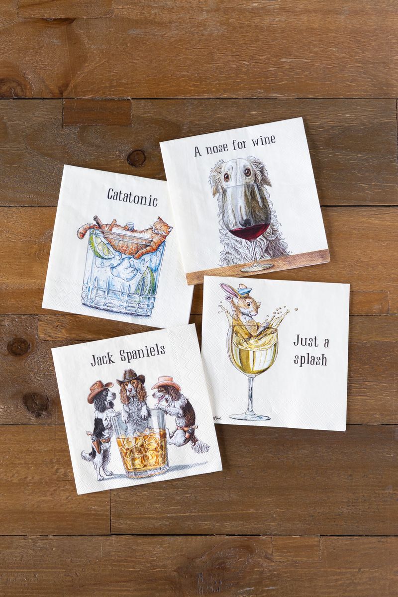 Four funny animal themed illustrated cocktail napkins on a wooden surface.