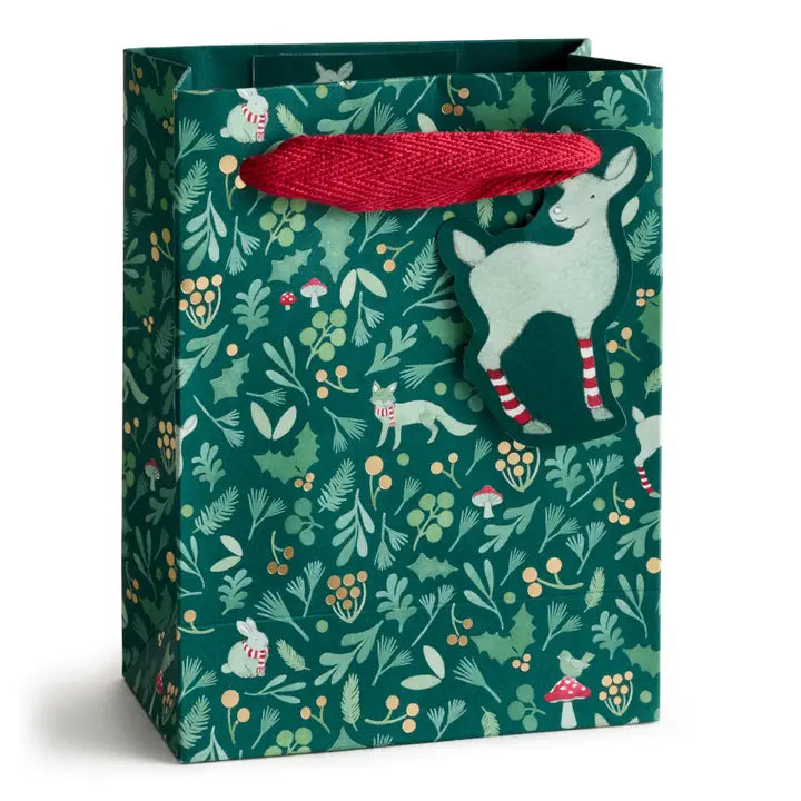 Gift bag with forest-themed design featuring animals and foliage on a white background