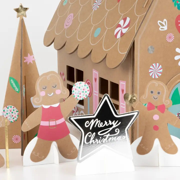 Gingerbread house with decorative gingerbread people and a &
