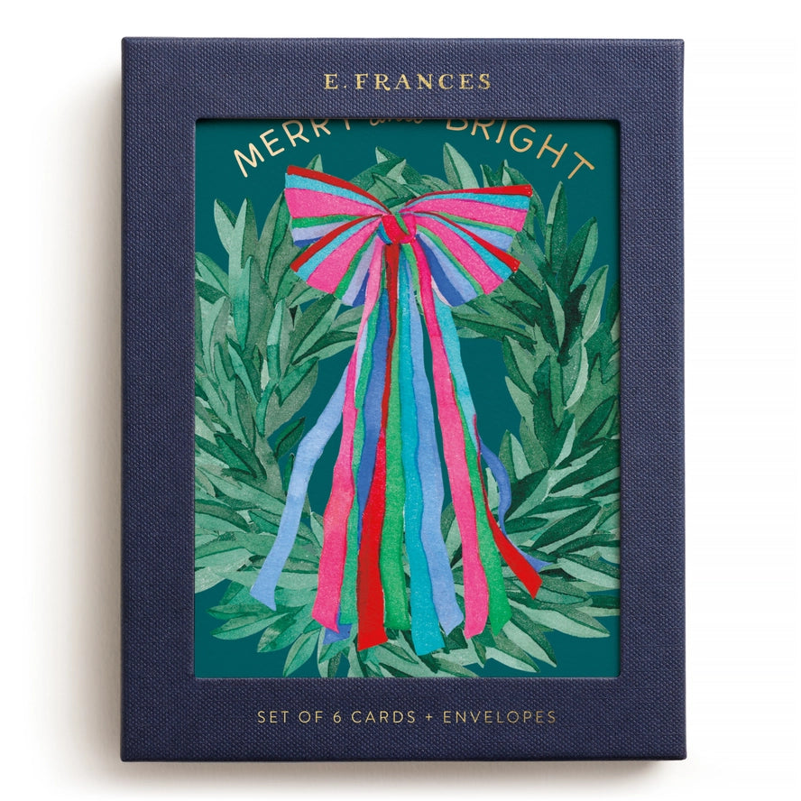 Set of 6 cards and envelopes with a colorful bow design on a green leafy background, branded &