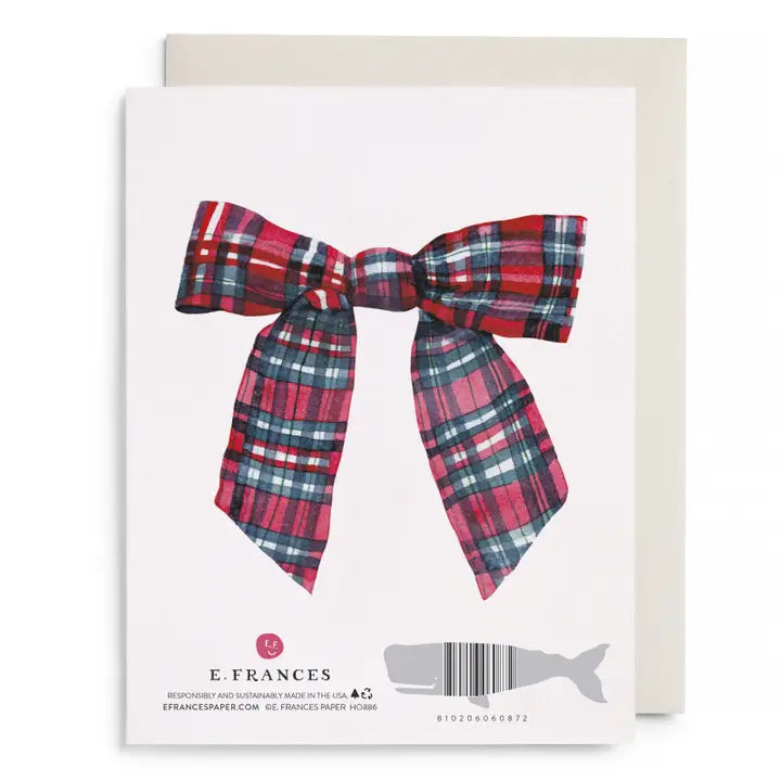 Card with a red and blue plaid bow on a white background, featuring the brand &