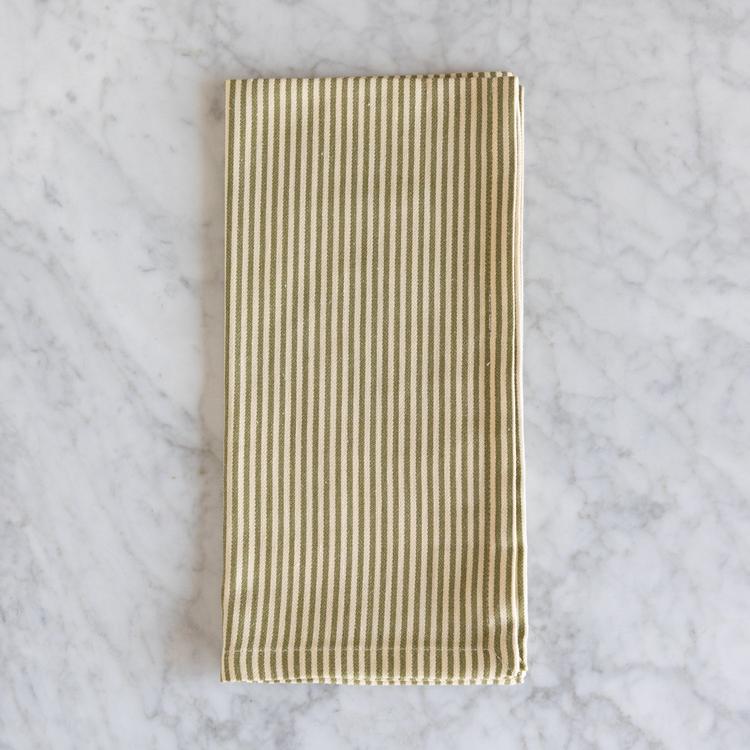 Striped fabric napkin on a marble surface.