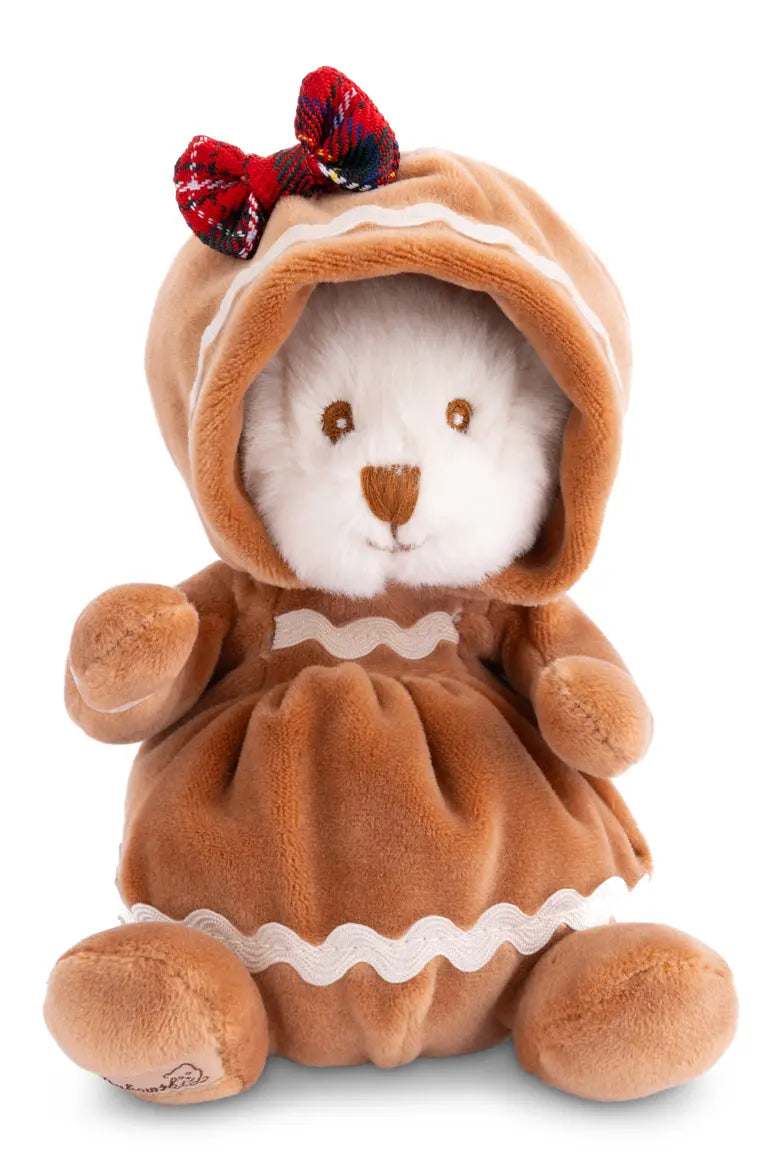 A plushie bear wearing a gingerbread costume with a plaid head bow on a white background.