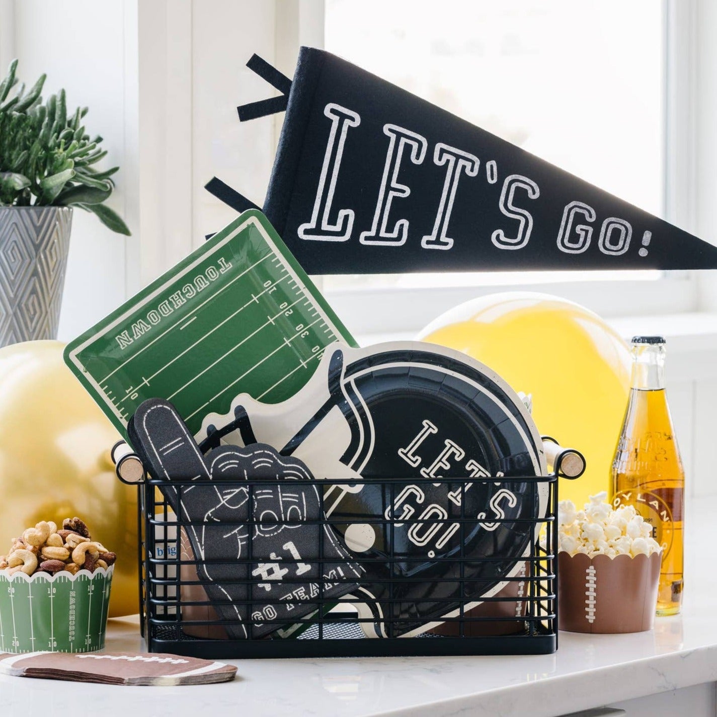 Football themed table setting with various snacks.