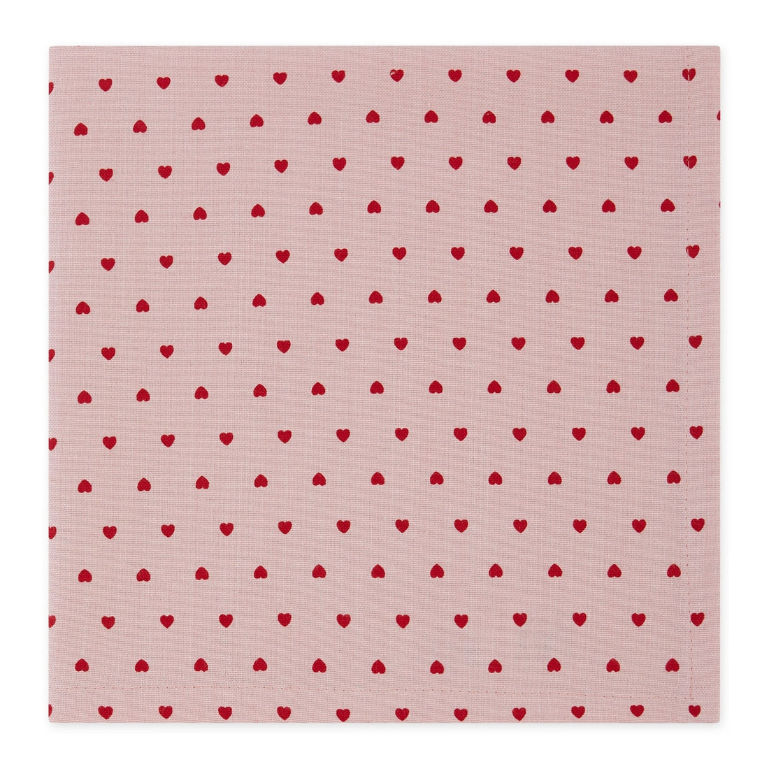 A square pink fabric napkin with a repeating pattern of small red hearts, shown flat against a white background.
