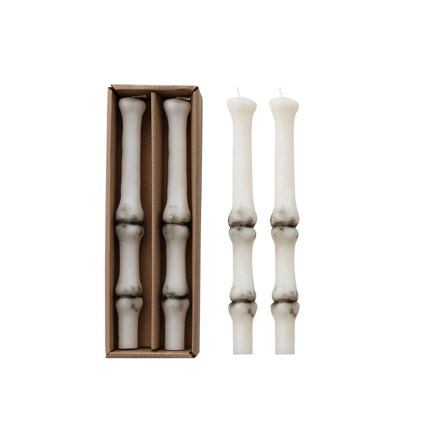 Two Unscented Finger Bone Shaped Taper Candles packaged and two on a white background.