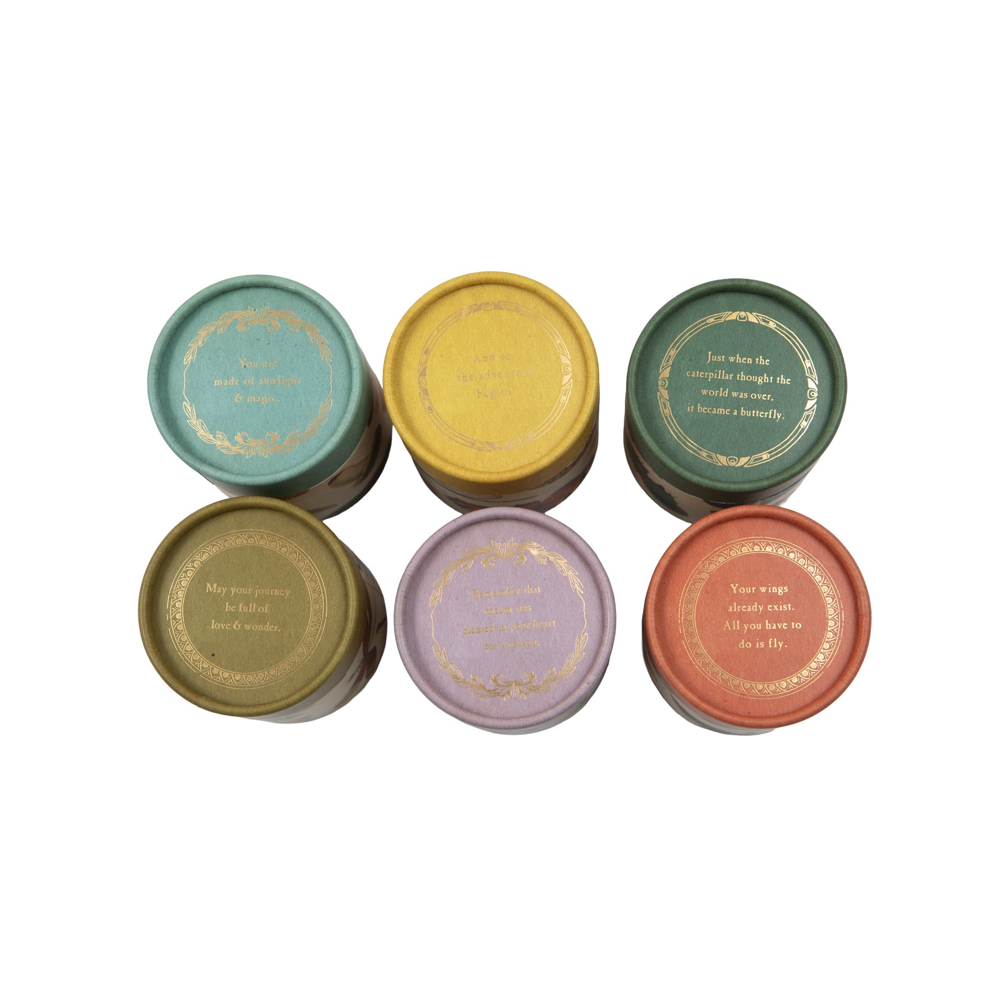 Set of six colorful candles with decorative lids on a white background.