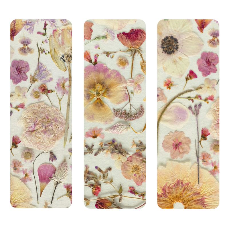 Three book marks with pressed floral design on a white background