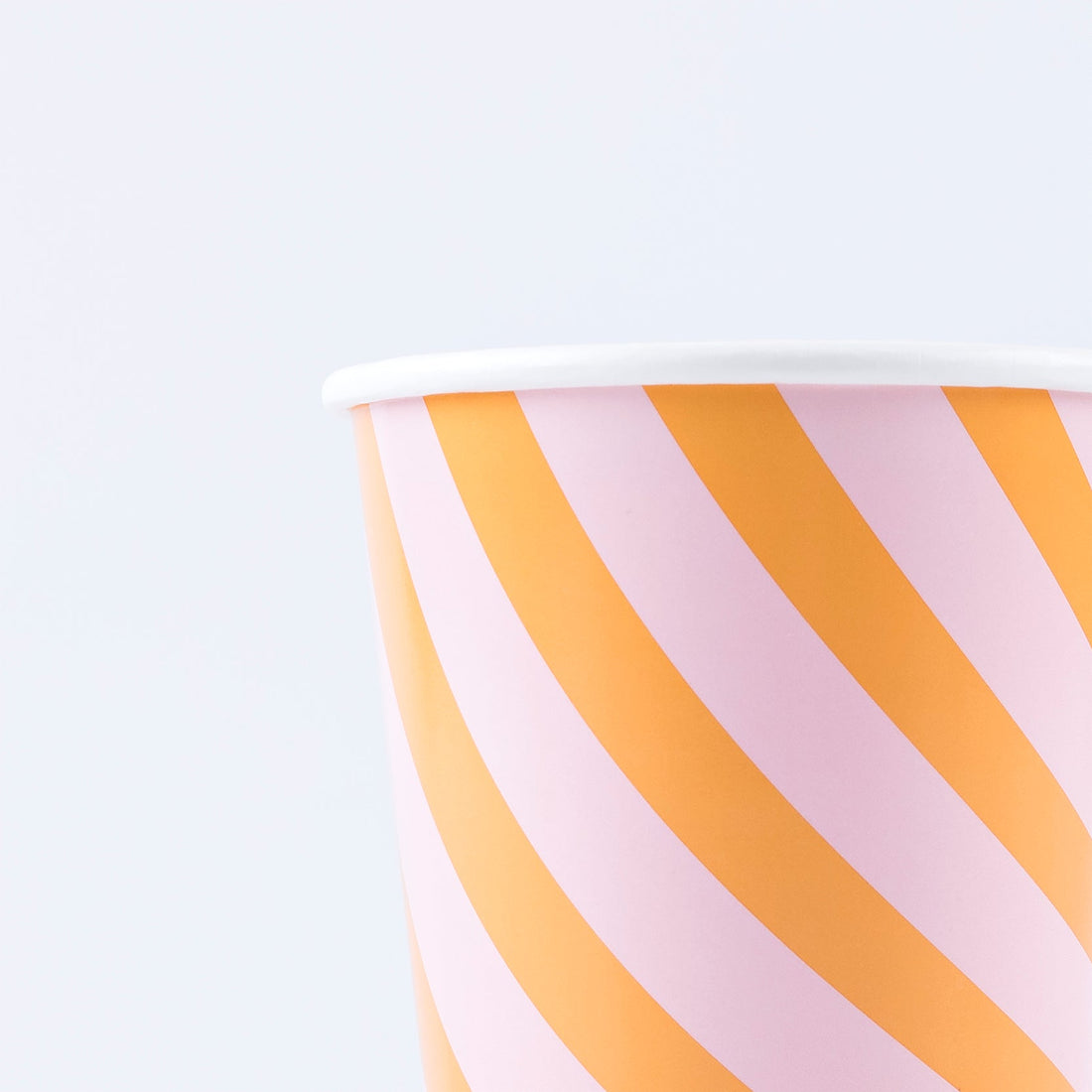 close up of Pink and orange stripy paper cup